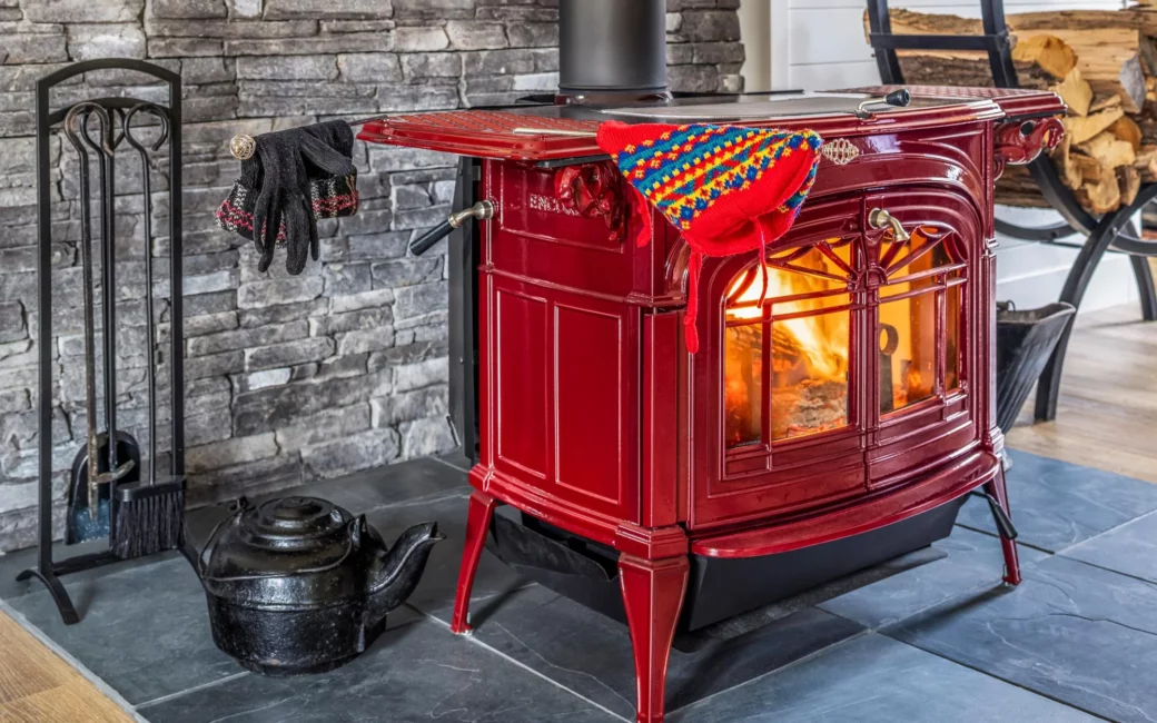Red wood stove on stone hearth