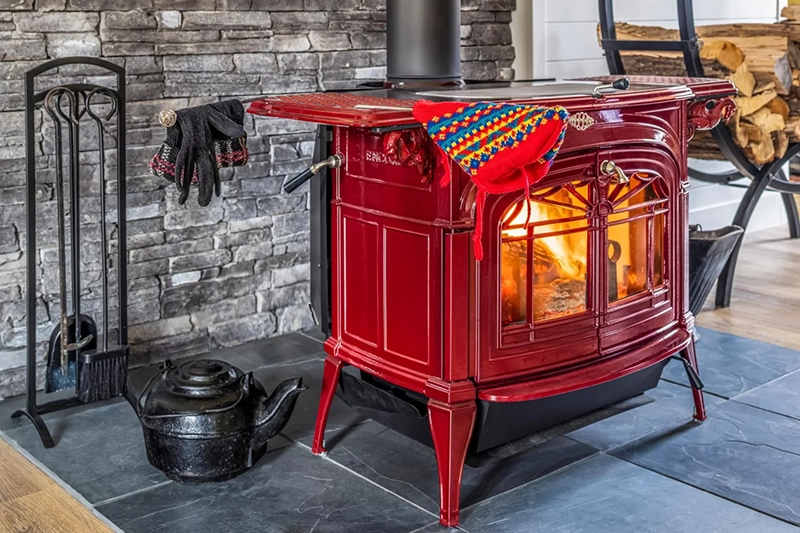 Red vintage standalone fireplace in a home