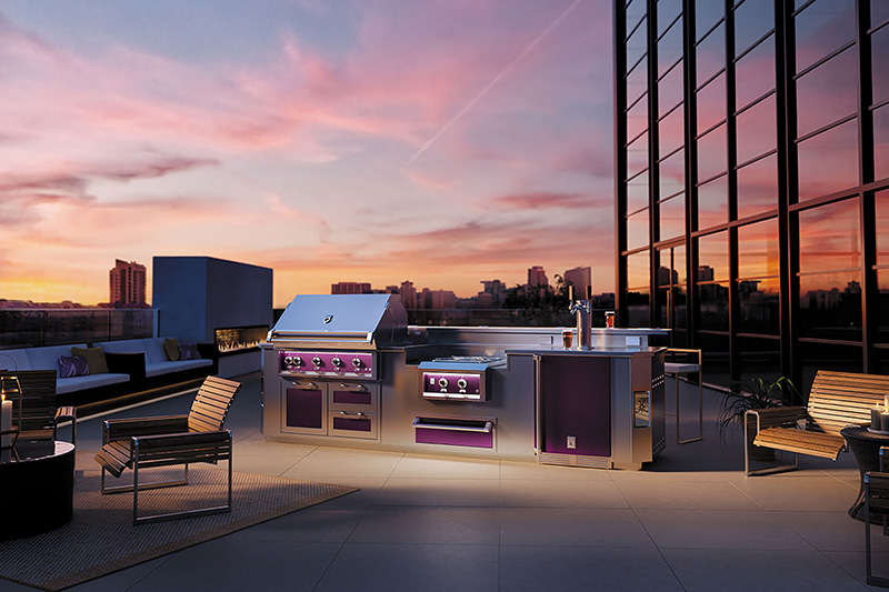 A grill range with purple accents on a building balcony overlooking a cityscape in the afternoon