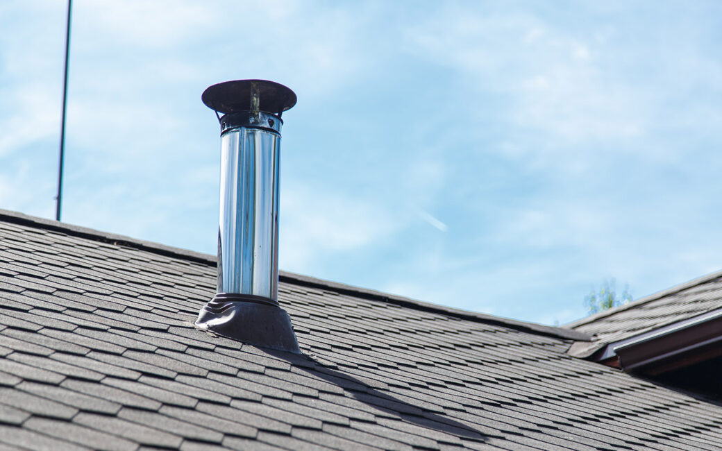 Chimney pipe from stainless steel on the roof of the house
