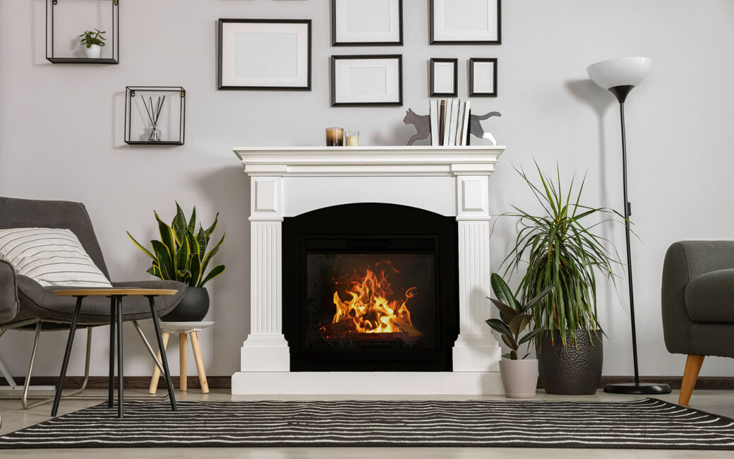 Stylish living room interior with fireplace, grey armchairs and side table