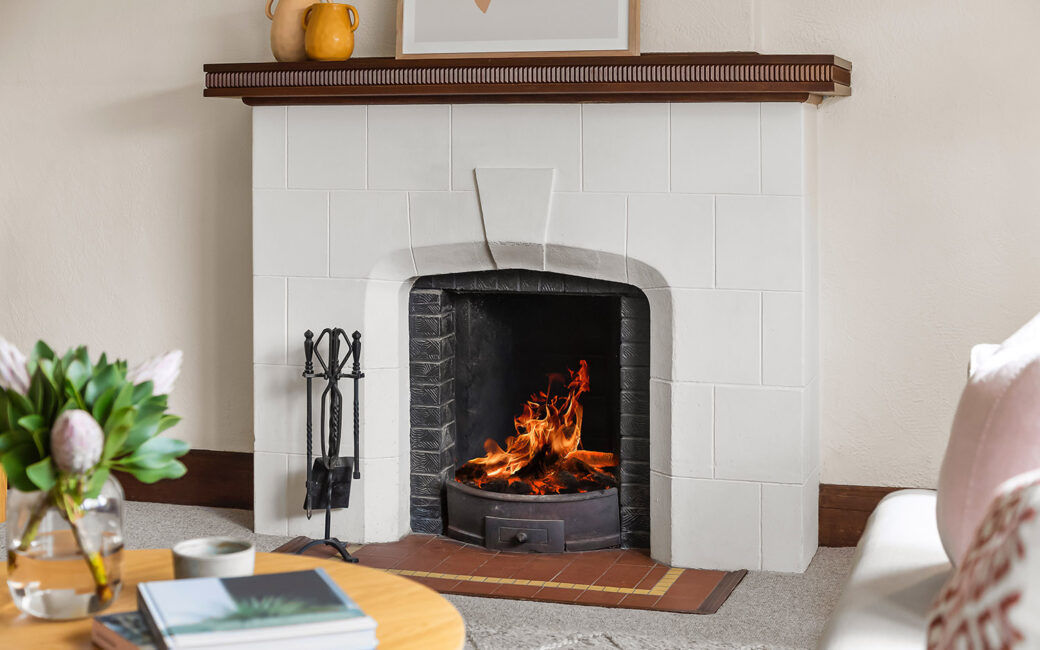 A wood fireplace with a white brick exterior.