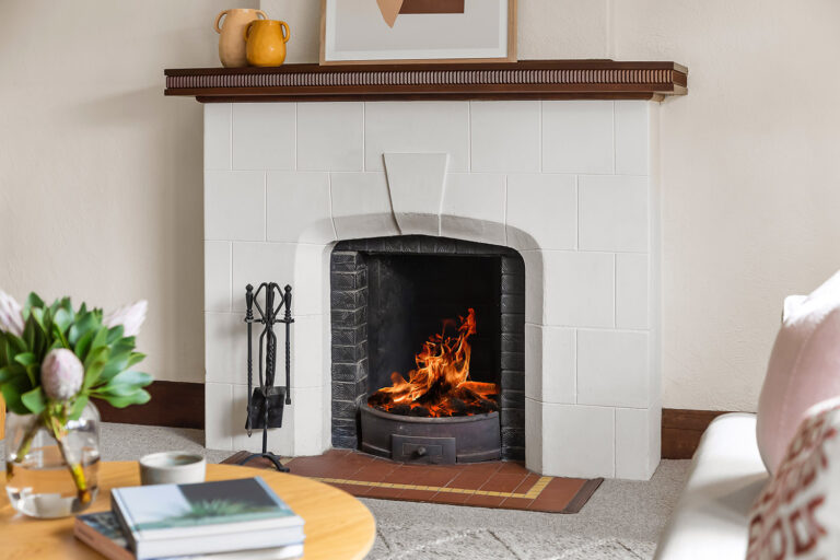 A wood fireplace with a white brick exterior.
