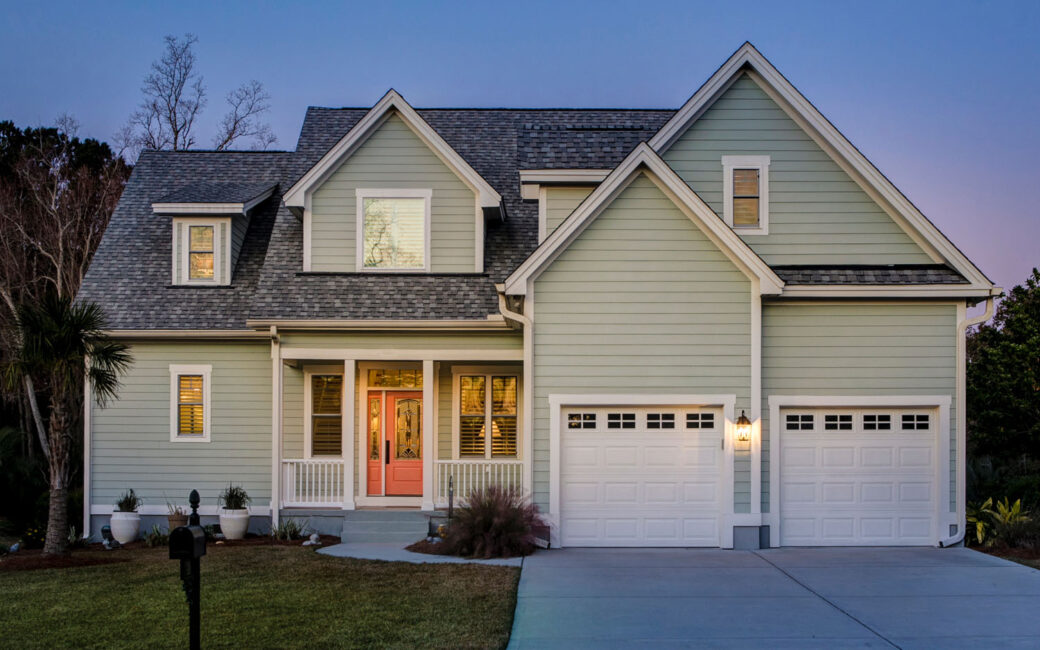 Front elevation of beautiful home lit up at twilight.