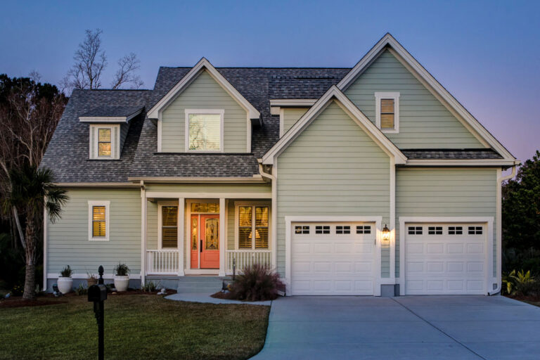 Front elevation of beautiful home lit up at twilight.