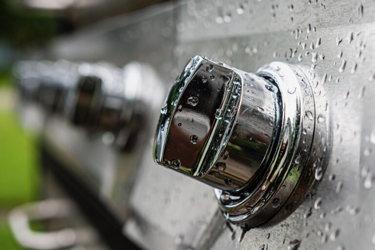 drops of water in a switch panel on the electric stainless steel grill, close-up